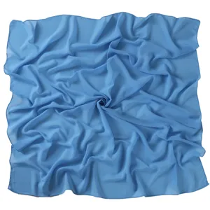 Detail view of the soft blue chiffon square scarf, showing smooth fabric texture and fine edge.