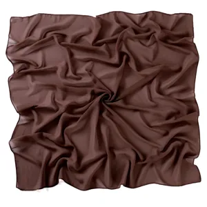 Brown chiffon square headscarf detail view, showing soft texture and elegant fabric drape.