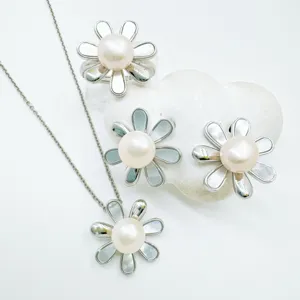Detailed shot of elegant pearl flower jewelry set necklace ring earrings with shell petals.