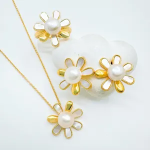 Gold-plated daisy pearl jewelry set detail showing pendant necklace, earrings, and ring.