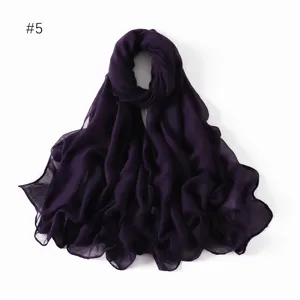 Detail shot of the solid dark purple lightweight polyester scarf, elegant drape texture.