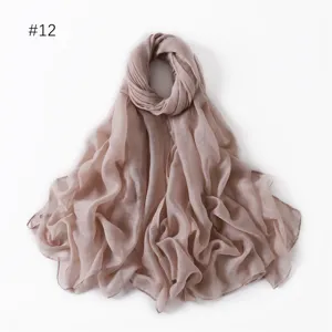 Detailed view of lightweight solid color voile long scarf fabric texture and soft drape.