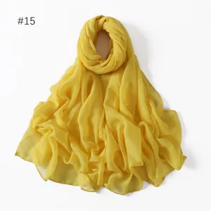 Close-up detail of the lightweight solid yellow polyester voile scarf, soft fabric texture.