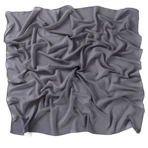 Detail view of a solid dark grey Malaysia pearl chiffon square scarf hijab, soft fabric.