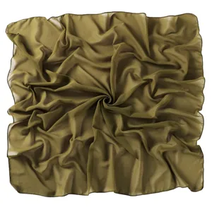 Close-up detail of the olive green chiffon square scarf showing soft texture and fine rolled hem.