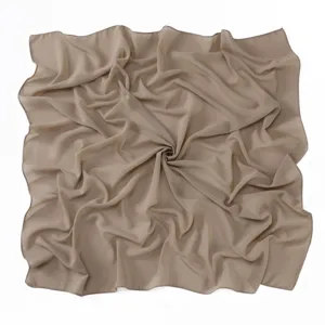 Close-up detail view of a solid color pearl chiffon square hijab scarf in elegant khaki.