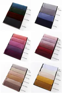 Detail view showing thirty beautiful color swatches of modal jersey hijab scarves in trays.