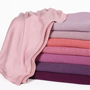 Detailed view of soft modal jersey hijab scarves in various solid pink and purple shades.