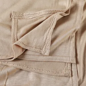 Close-up view of the smooth modal jersey fabric and fine stitching details of the scarf.