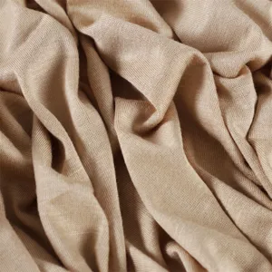 Close up view of soft modal jersey fabric texture, smooth drape and solid color detail.