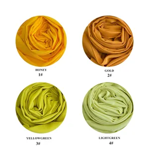 Detailed view of solid color chiffon hijab fabric swatches in four vibrant yellow and green tones.