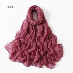 Detail view of a lightweight solid color sheer voile scarf, elegant draped fabric style.