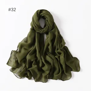 Detailed view of solid color voile long scarf in dark army green, lightweight texture.