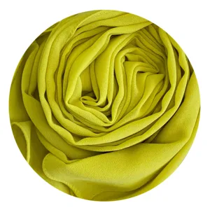 Detailed view of lime green chiffon hijab fabric texture, soft drape and elegant wrinkle design.