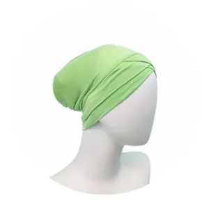 Detailed view of light green modal cross turban hijab cap inner breathable fabric design.