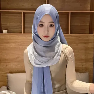 Detail shot of the shimmering gradient satin hijab scarf, showing smooth texture and beautiful drape.