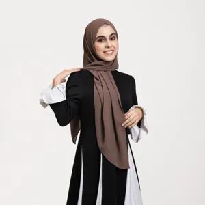 Elegant black and white dress with brown hijab, perfect for modest daily wear.
