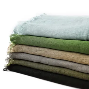 Close-up detail of soft rayon pleated scarf with fringed edges in multiple solid colors.