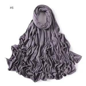 Detailed shot of a solid color modal jersey long scarf, showing soft draped fabric texture.