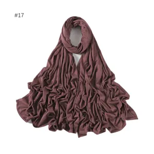 Close-up detail of soft modal long hijab scarf in dusty rose color, smooth fabric texture.