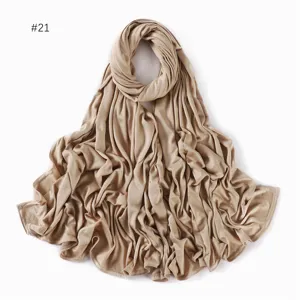 Detailed view of a solid khaki modal long scarf, soft jersey fabric hijab wrap for women.