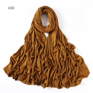 Detailed close-up of soft modal jersey hijab scarf in caramel brown, showing smooth texture.