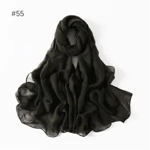 Solid dark green lightweight crinkled voile long scarf detail, soft breathable fabric accessory.