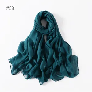 Solid color lightweight polyester long scarf detail view, simple and versatile travel accessory.
