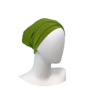 Close-up detail of green modal cross wrap hijab inner cap showing texture and fold design.