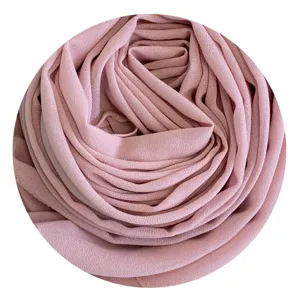 Detailed close-up view of a soft pink chiffon hijab showing fine and delicate pleats.