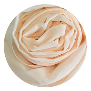 Detailed close-up view of a soft chiffon hijab rolled into a lovely flower shape.