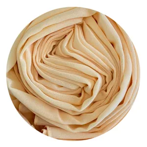 Soft peach chiffon fabric detail showcasing delicate folds and smooth texture for hijab.