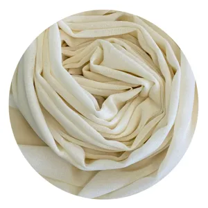 Close-up detail of soft beige chiffon hijab fabric showing delicate texture and fine weave.