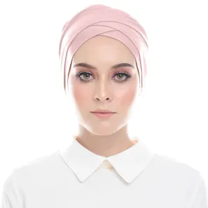 Close-up detail of soft modal cross turban inner hijab cap in solid pink color style.