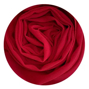 Red chiffon hijab fabric detail, soft texture and solid color scarf closeup view.