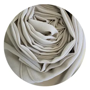 Close-up detail of soft beige chiffon hijab fabric texture, elegant solid color scarf fold.