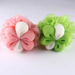 Close-up detail shot of soft mesh bath sponge loofah, dual color pink and green petal design.