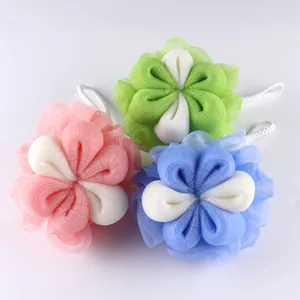 Detailed view of colorful mesh bath sponge set, flower shaped shower puff for body care.