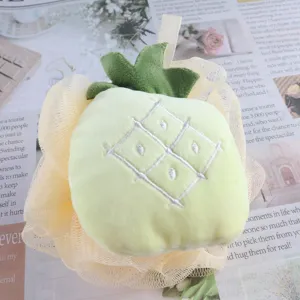 Cute fruit bath sponge detail shot showing soft mesh texture and plush green leaf top decor.