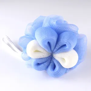 Close-up detail of soft mesh bath sponge in blue and white, fluffy shower puff design.