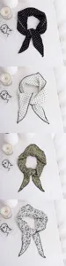 Printed triangular scarf detail, chic dot and floral patterns, elegant accessory.