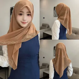Detailed view of the elegant chiffon hijab scarf featuring sparkling rhinestone leaves and pearl details.