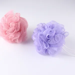 Close up view of soft mesh bath sponges in pink and purple colors with hanging string.