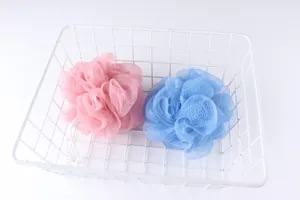 Soft mesh bath sponge set in pink and blue colors with a white wire storage basket for daily use.