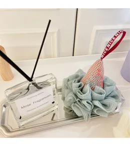 Close-up detail of the ice cream shaped soft mesh bath sponge with cute ribbon and embroidery.
