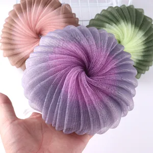 Close-up detail of large gradient mesh bath sponge, soft nylon puff for body washing.