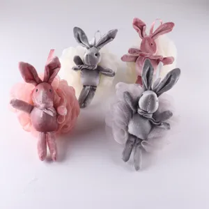 Close-up detail of cute plush bunny bath sponge, soft mesh shower puff, pink and gray cute toy.