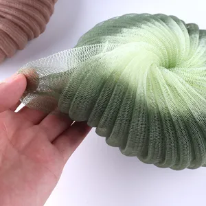 Detailed view of a gradient green mesh bath sponge, large sunflower bath ball for daily use.