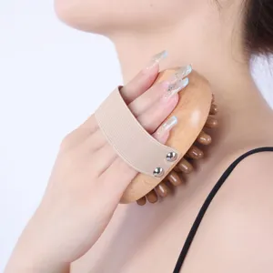 Wooden meridian massage brush detail showing ergonomic handle and smooth wooden bristles for body.
