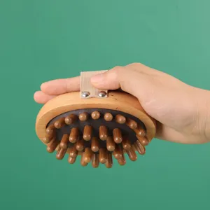 Wooden meridian massage brush detail featuring smooth round wooden bristles and grip strap.